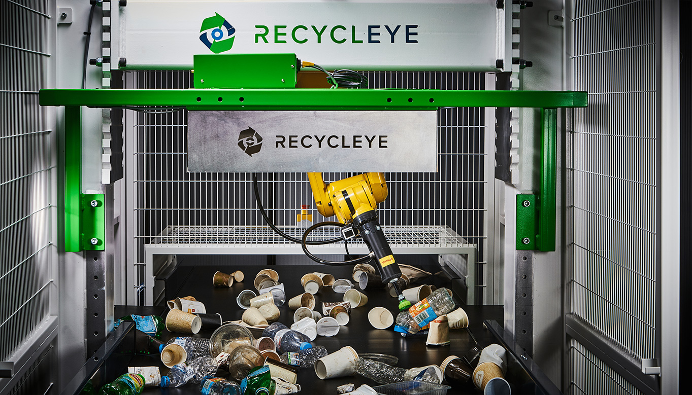 robotic arm sorting waste materials such as card, metal and plastic